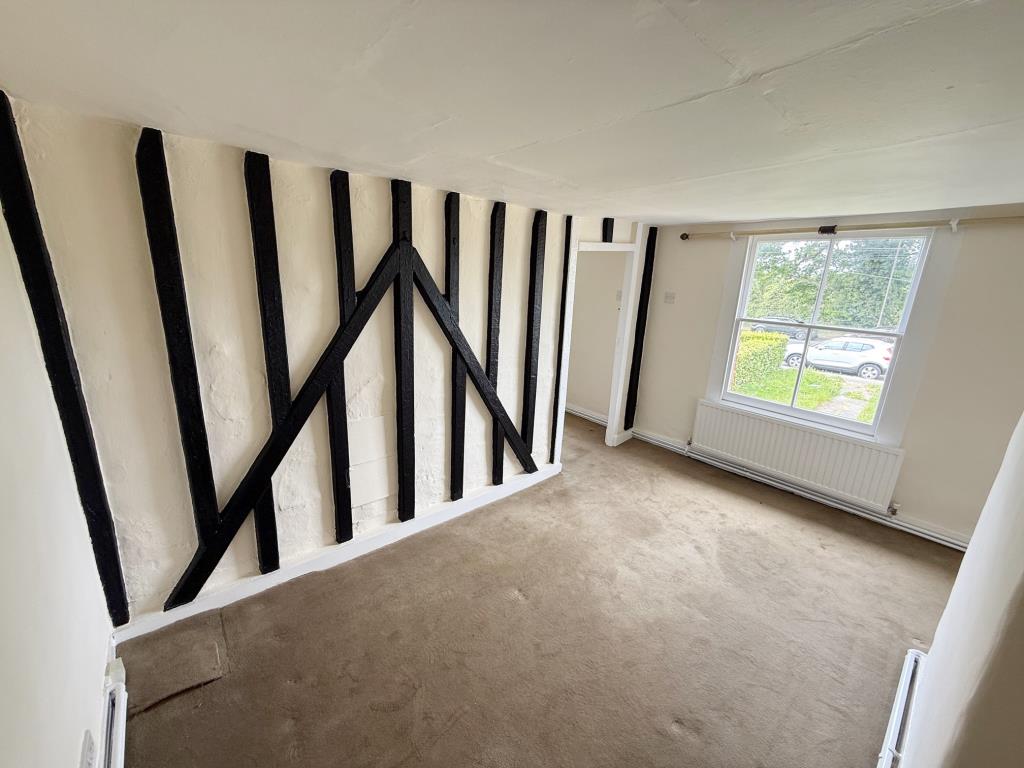 Lot: 165 - MID-TERRACE COTTAGE FOR IMPROVEMENT - Bedroom 1 with expose studwork and window to front